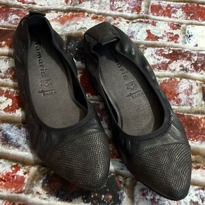 Tamari’s dark navy leather, flat with snake detail